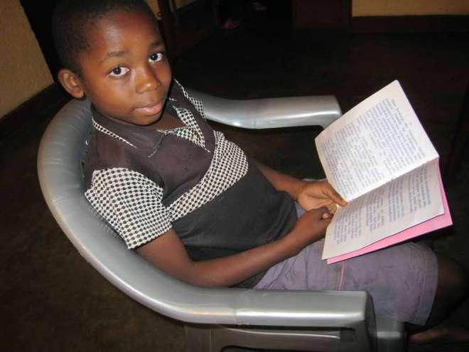 Congolese boy reading the Gospel of Luke in his language - Tembo